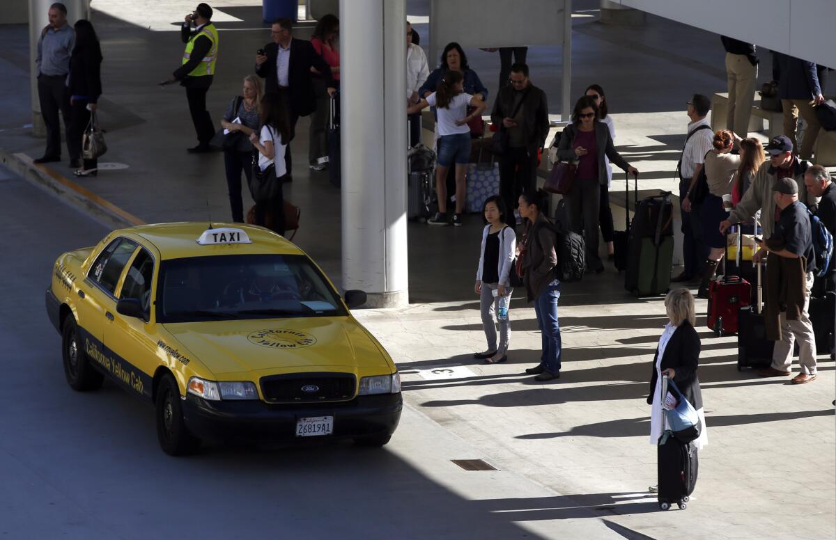 Uber and Wingz joined taxicabs this week in giving travelers rides from John Wayne Airport in Santa Ana. Ride-share companies received permits to provide airport service.