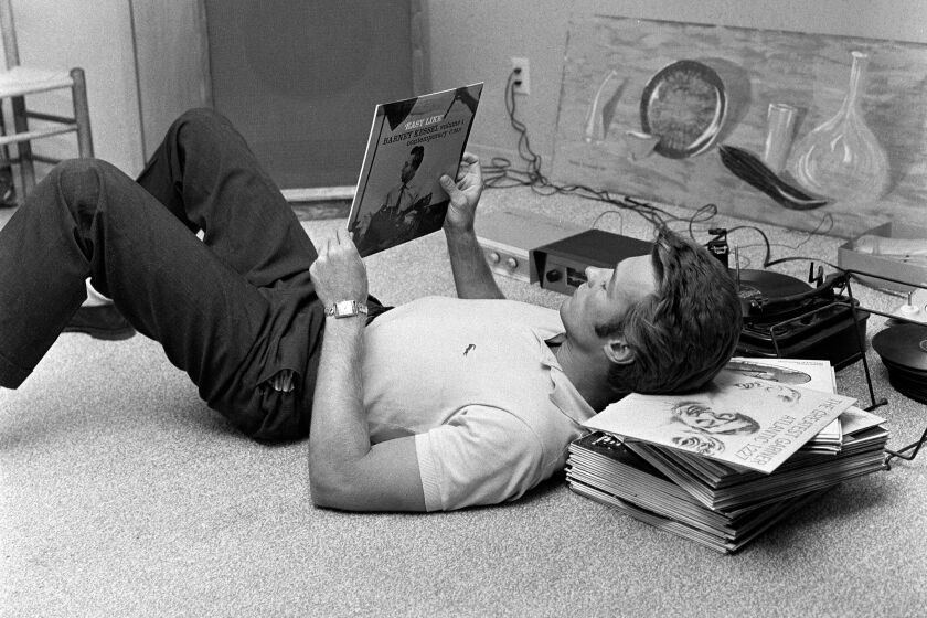 American actor Clint Eastwood listens to records at his home, October 1, 1959. (Photo by CBS Photo Archive/Getty Images)