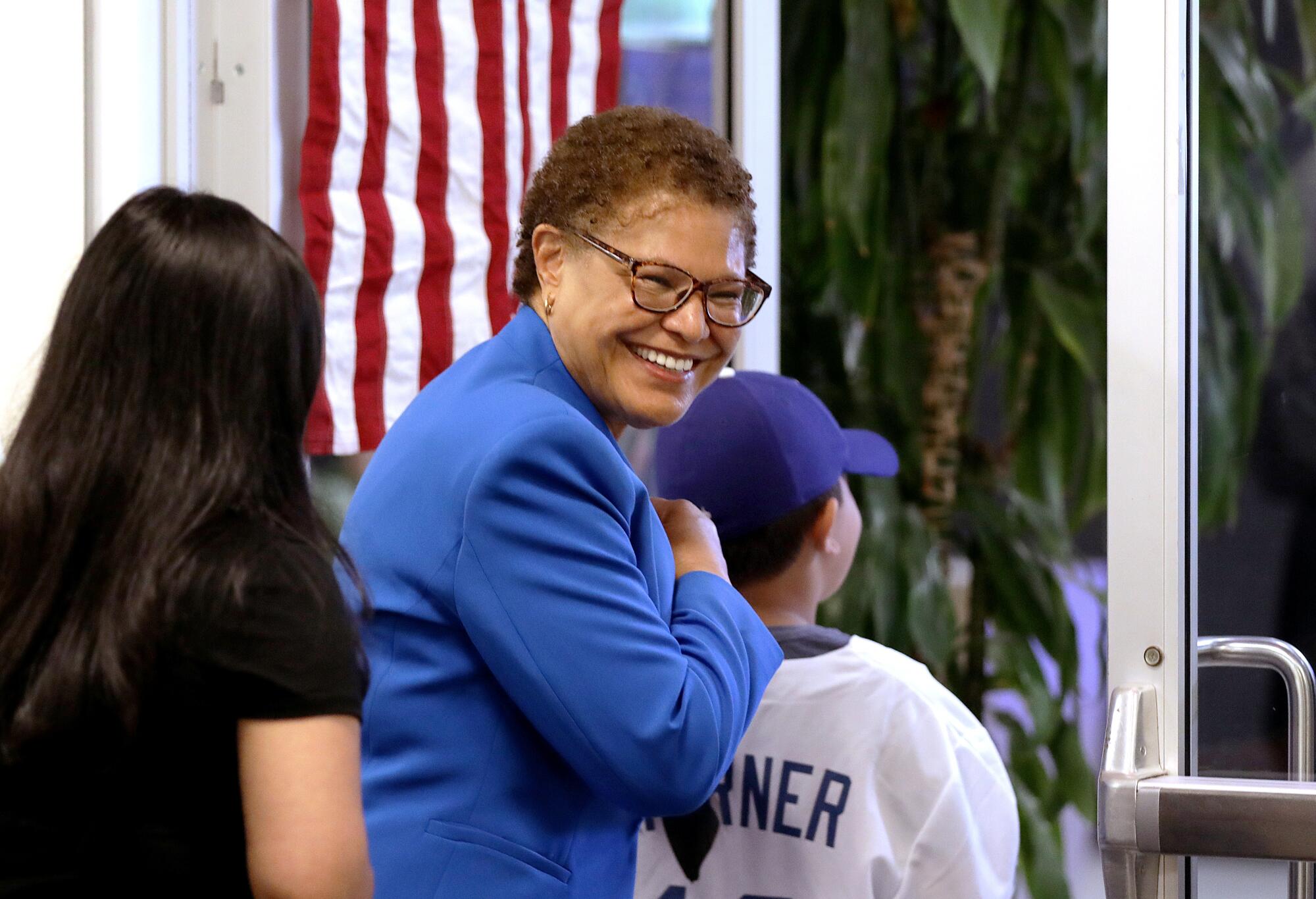 Karen Bass leaving a polling place with a young woman and boy