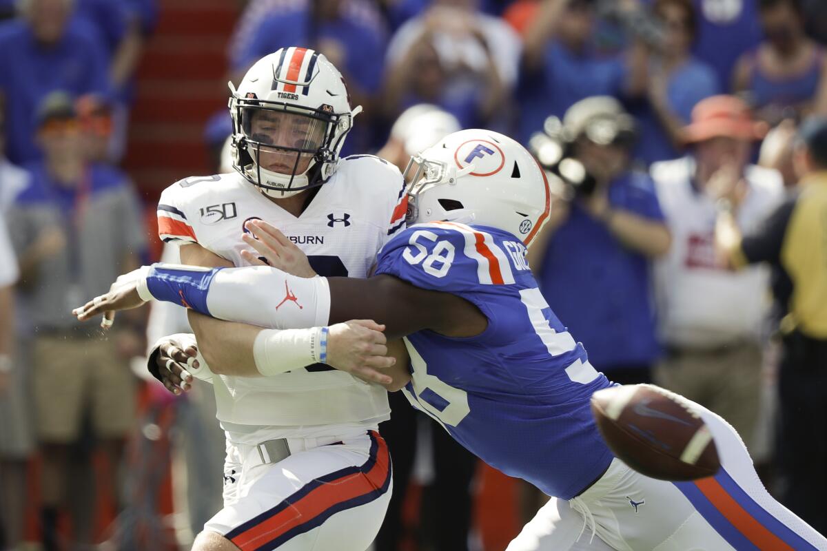 Auburn quarterback Bo Nix is hit by Florida linebacker Jonathan Greenard as he tries to pass during the first half Saturday.