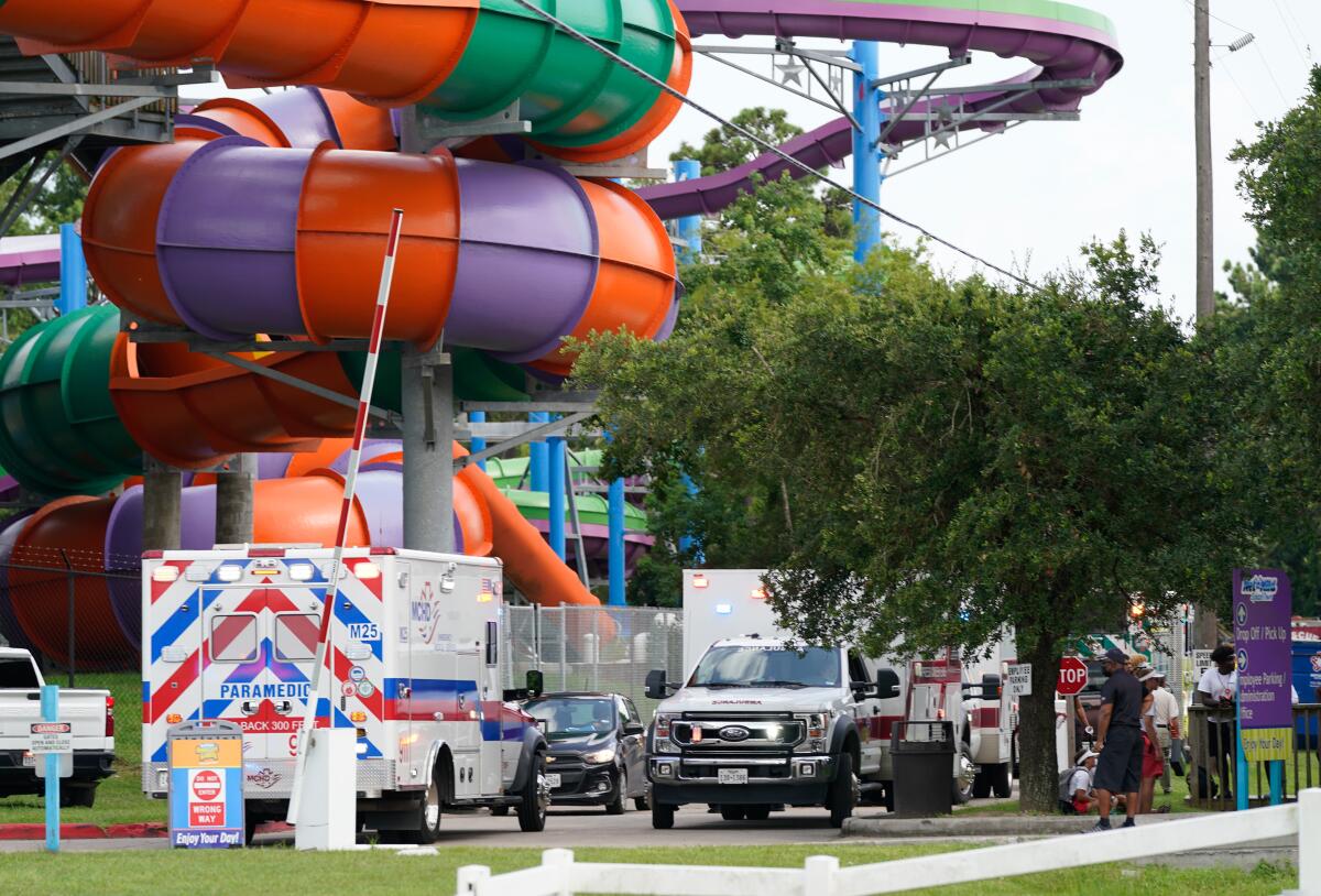 FILE - Emergency personnel vehicles are parked near the scene where people are being treated after chemical leak at Six Flags Hurricane Harbor Splashtown on July 17, 2021 in Spring, Texas The Texas water park says a chemical exposure that sent dozens of people to hospitals was caused by “improper installation” of a water filtration system, Wednesday, Aug. 4. (Melissa Phillip/Houston Chronicle via AP)