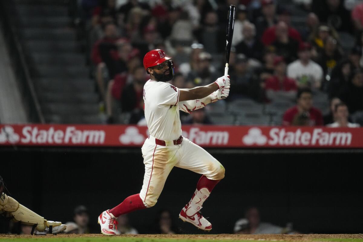 Jo Adell hits a double during the eighth inning of the Angels' 2-1 win over the San Diego Padres at Angel Stadium.