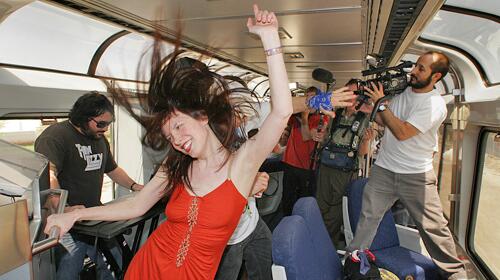 INDIO OR BUST: Kestrin Pantera dances to a live DJ aboard a special Amtrak charter , the Coachella Express, a free train service from Union Station that's providing transportation for campers heading to the Coachella Valley Music & Arts Festival.