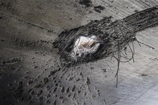The impact of an explosion is visible on the roof of a hangar following an Isra