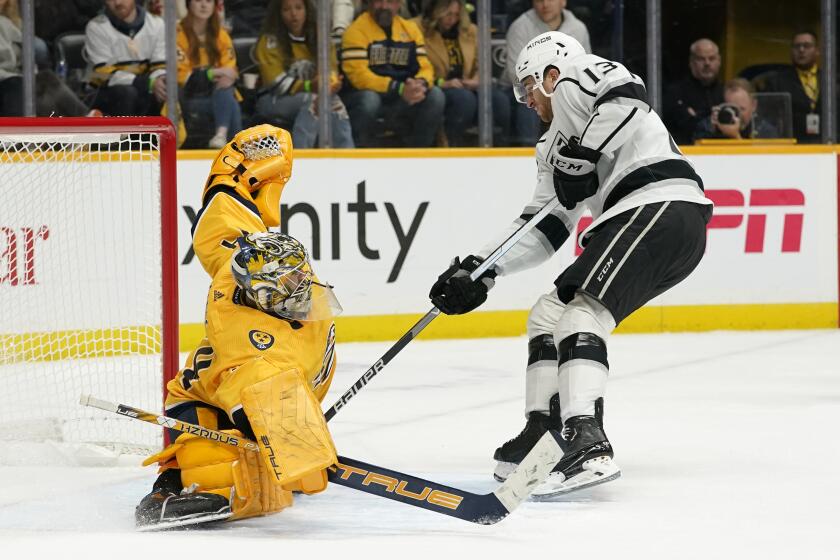 Los Angeles Kings' Gabriel Vilardi (13) scores the winning goal against Nashville Predators goaltender Juuse Saros, left, during a shootout in an NHL hockey game Tuesday, Oct. 18, 2022, in Nashville, Tenn. The Kings won 4-3. (AP Photo/Mark Humphrey)