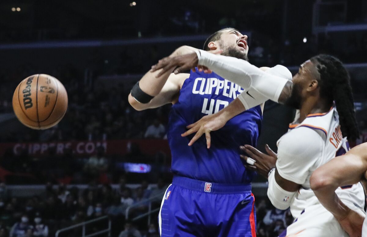 Phoenix Suns forward Jae Crowder, right, knocks the ball away from Clippers center Ivica Zubac during the first half.