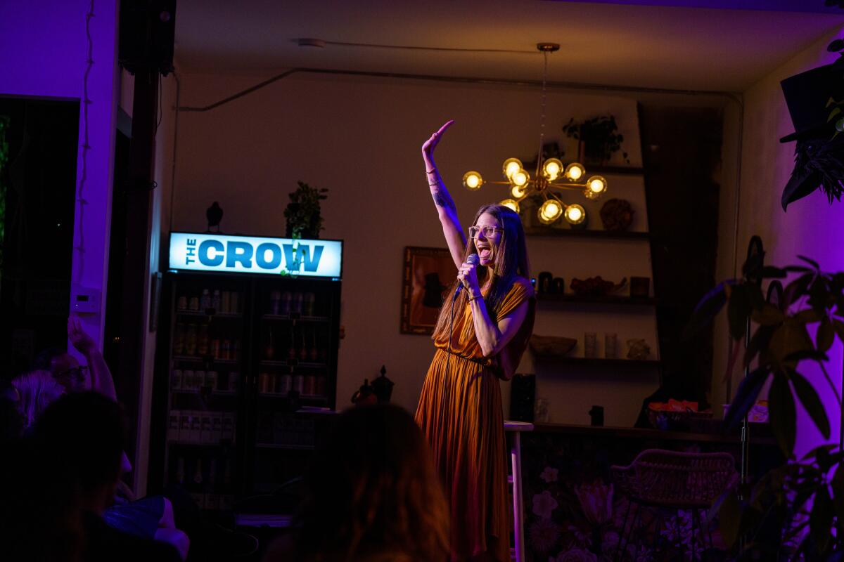 Nicole Blaine, co-founder of the Crow comedy club and creator of Bergamot Comedy Fest, onstage waving