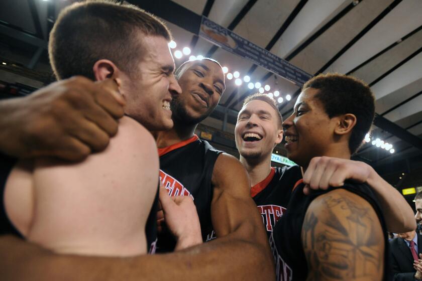 Northeastern players, left to right, Caleb Donnelly, Kwesi Abakah, Jimmy Marshall and T.J. Williams celebrate their upset victory over William and Mary in the Colonial Athletic Association conference tournament.