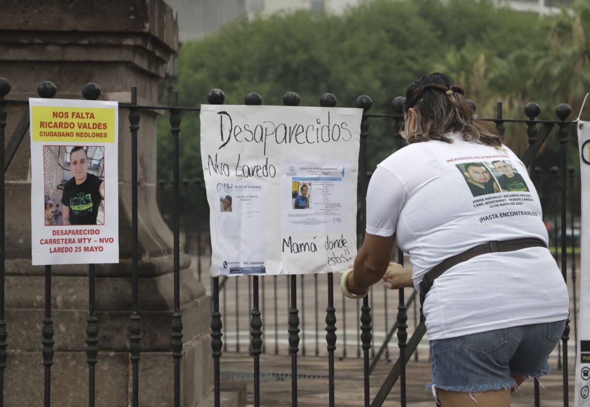 Family of Ricardo Valdes, who disappeared on the road on May 25, placed missing posters during a protest in Monterrey, Nuevo Leon state, Mexico, Thursday, June 24, 2021. As many as 50 people in Mexico are missing after they set off on simple highway trips between the industrial hub of Monterrey and the border city of Nuevo Laredo; relatives say they simply disappeared on the heavily traveled road, which has been dubbed 'the highway of death,' never to be seen again. (AP Photo/Roberto Martinez)
