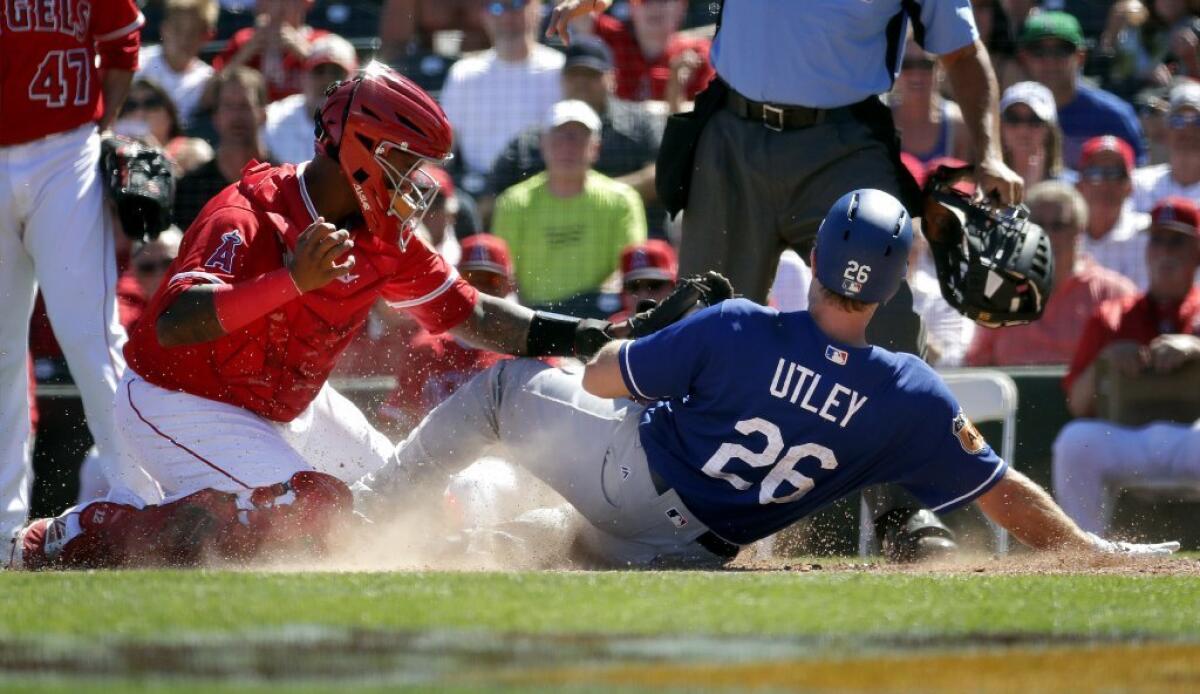 Dodgers second baseman Chase Utley (26) is tagged out at the plate by Angels catcher Martin Maldonado during the second inning on March 13.