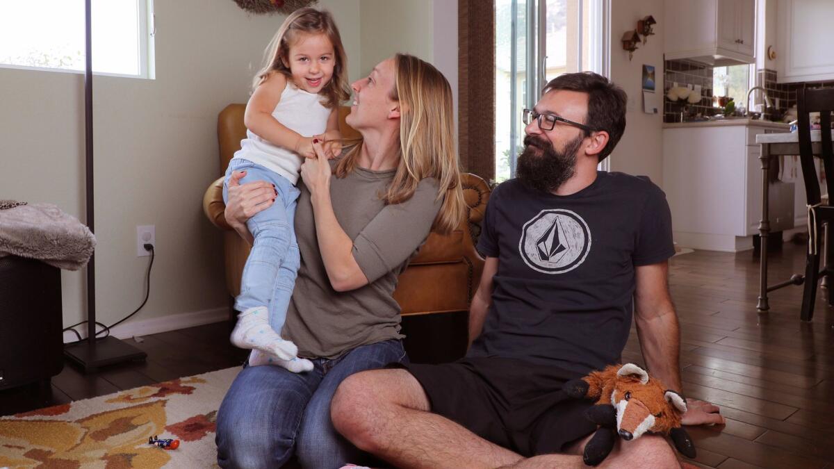 Portrait of Mark and Jennifer Landis and their 3-year-old daughter Taylor, photographed March 4 at their Fallbrook home.
