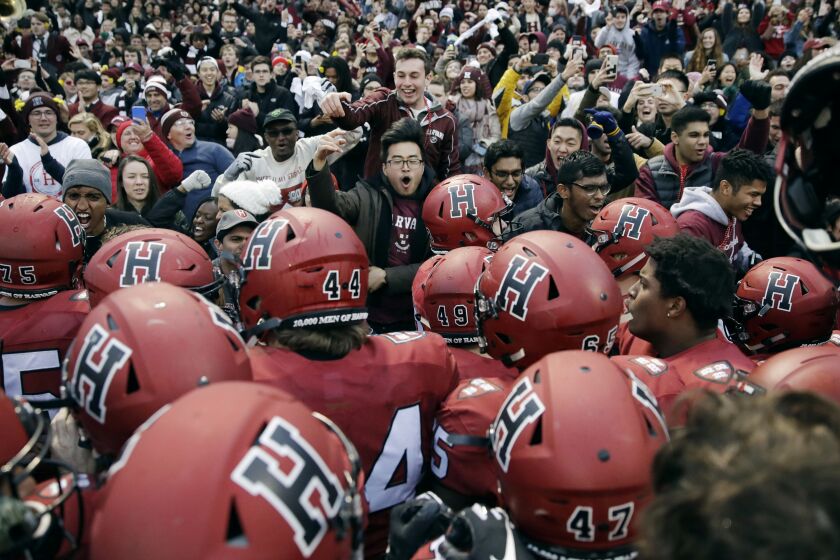 FILE - In this Nov. 17, 2018, file photo, Harvard players, students and fans celebrate their 45-27 win over Yale after an NCAA college football game at Fenway Park in Boston. Harvard defeated Yale. The Ivy League has canceled all fall sports because of the coronavirus pandemic. (AP Photo/Charles Krupa, File)