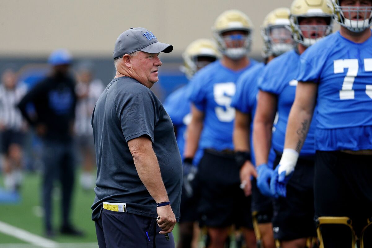 Coach Chip Kelly attends football practice on the UCLA campus.
