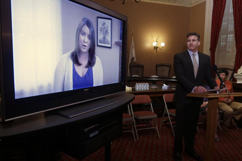 Dan Diaz, the husband of Brittany Maynard, watches a video of his wife, recorded 19 days before her assisted-suicide death in Oregon last year, at the Capitol in Sacramento on March 25.