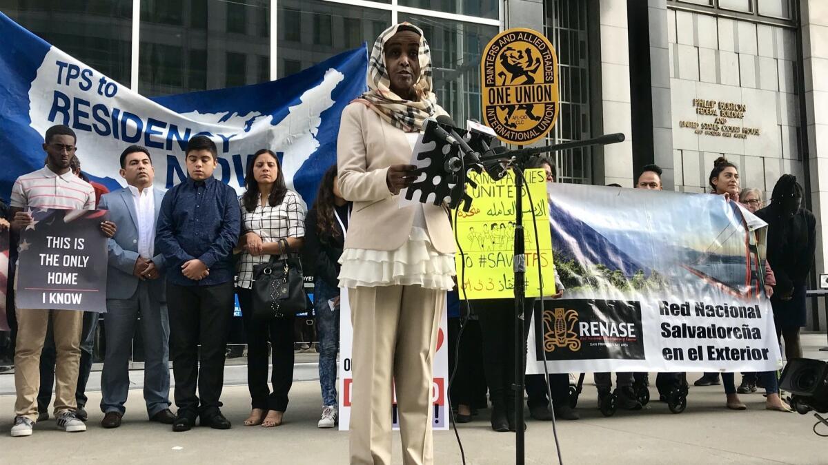Hiwaida Elarabi of Massachusetts speaks outside the federal building in San Francisco. Elarabi, an immigrant from Sudan and beneficiary of Temporary Protected Status, is a plaintiff in a lawsuit against the Trump administration over the termination of those protections.