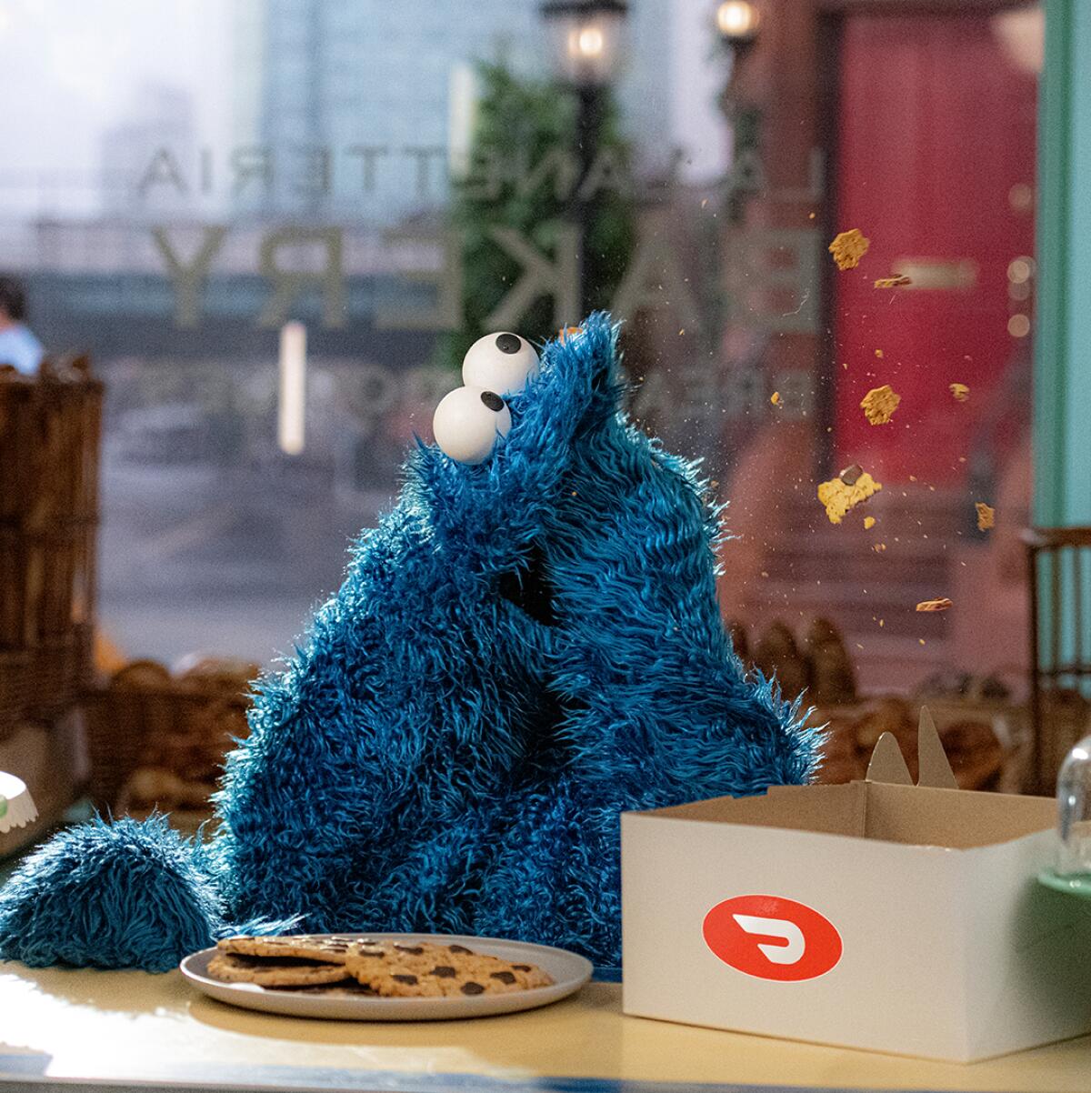 Cookie Monster eating cookies from a box