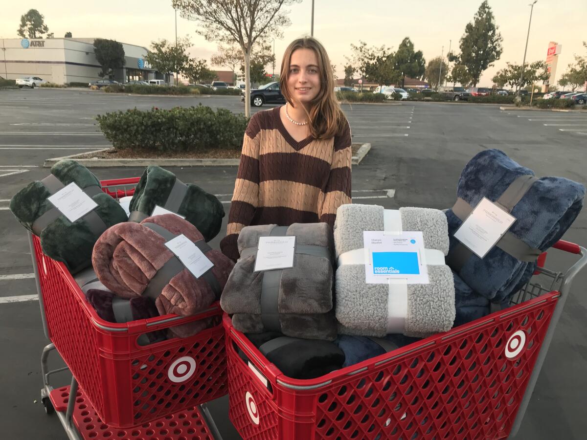 Lucie Babcock with some of the gift boxes for the Holiday Baskets program.