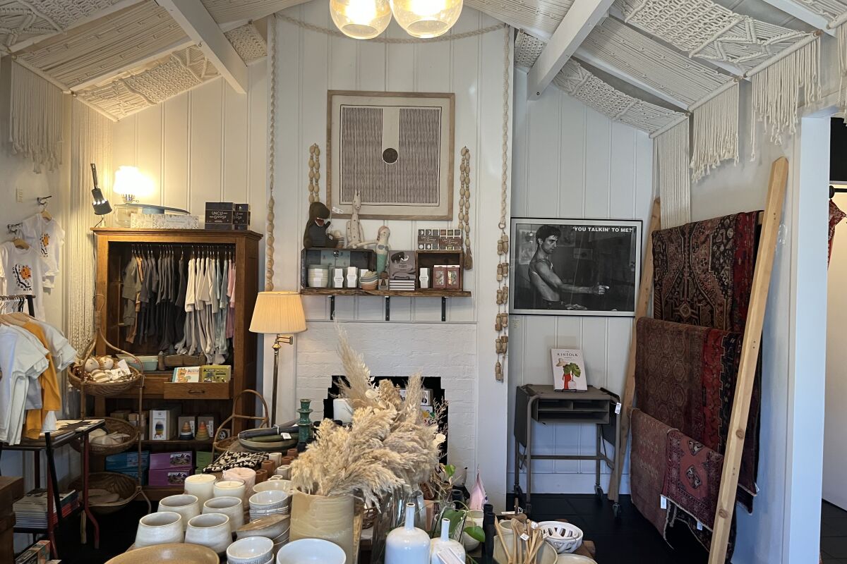 Clothing, ceramics, candles inside a store.