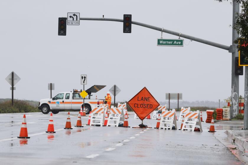 Huntington Beach, CA - February 5, 2024: The Southbound lanes of Pacific Coast Highway from Warner Avenue to Seapointe Street remain closed due to flooding in Huntington Beach on Feb. 5, 2024.(Allen J. Schaben / Los Angeles Times)