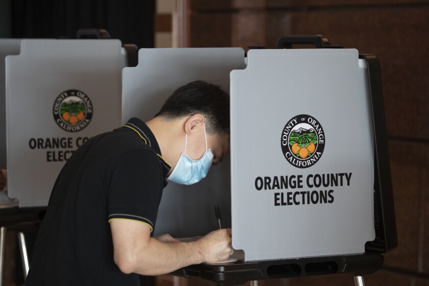 Quan Nguyen of Santa Ana votes early Monday at the Honda Center in Anaheim.