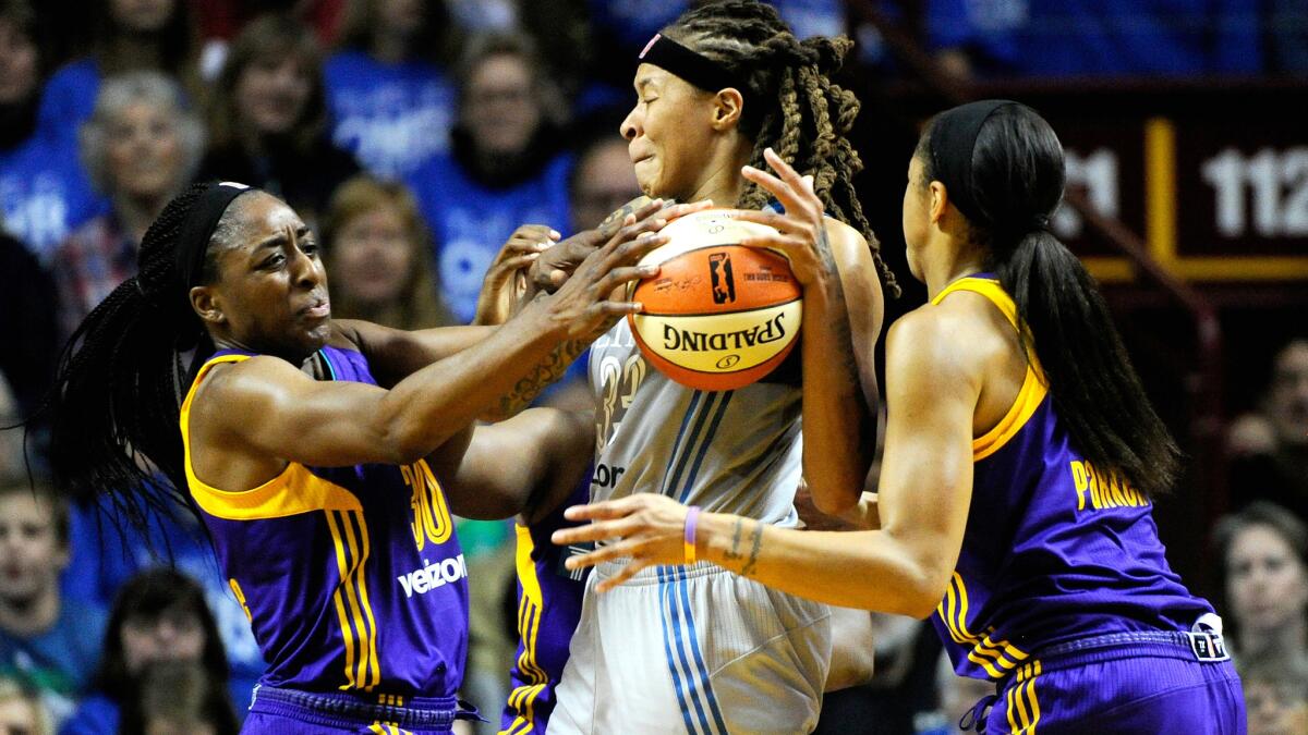 Sparks forwards Nneka Ogwumike (30) and Candace Park (3) double-team Lynx forward Maya Moore during Game 2 of the WNBA Finals.