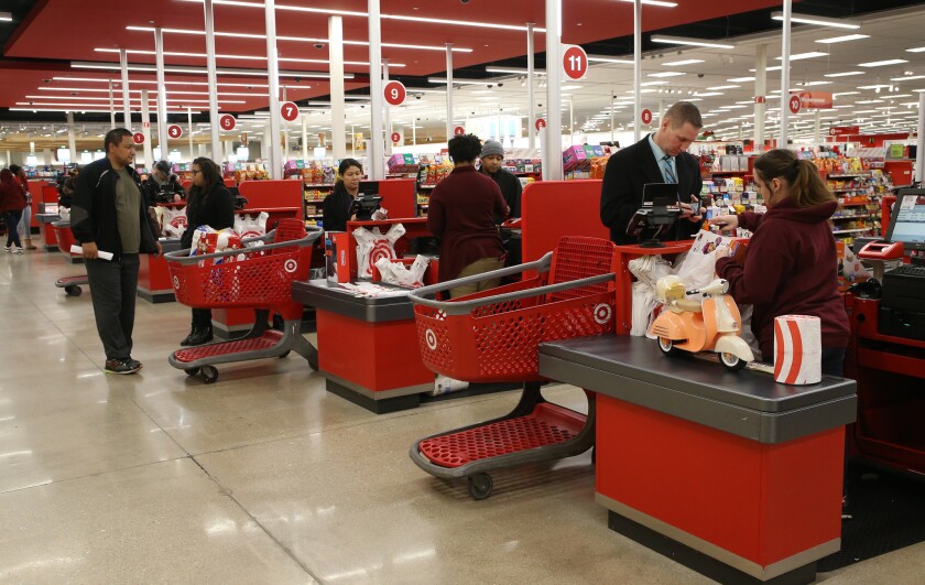 Shoppers pay for their purchases at a Chicago Target store on Friday, Nov. 24, 2017. The cost of food, shelter and gas have all risen significantly in the past year, according to federal data.