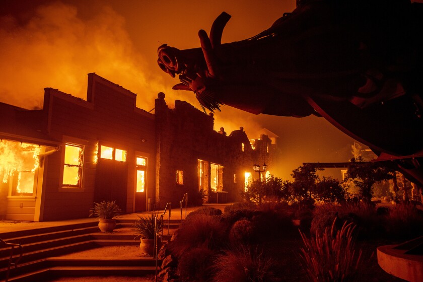 FILE - In this Oct. 27, 2019, file photo, flames from the Kincade Fire consume Soda Rock Winery in Healdsburg, Calif. A California prosecutor has charged troubled Pacific Gas & Electric with starting a 2019 wildfire. District Judge William Alsup overseeing Pacific Gas & Electric's criminal probation is holding a hearing Tuesday, May 4, 2021, to consider whether Pacific Gas & Electric violated its criminal probation from a fatal 2010 natural gas explosion by sparking the October 2019 Kincade Fire north of San Francisco.(AP Photo/Noah Berger, File)