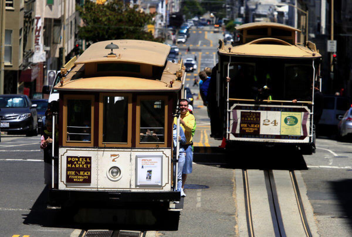 Cable cars on the Powell and Market line pass each other.