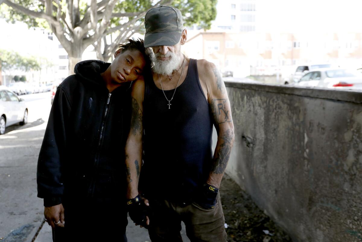 Leslie Whittington Silvia, 43, left, with Tony "Maddogg," 62, in L.A.'s Koreatown neighborhood on Sunday. Tony, who has colon cancer and has been homeless since 1989, lives in a tent near a temporary shelter that has been met with neighborhood opposition.