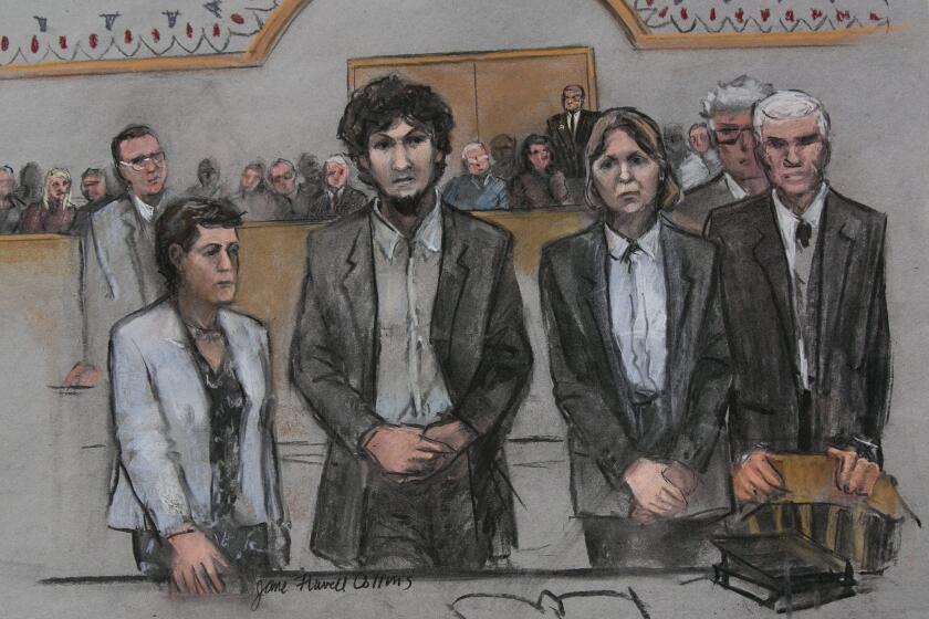 In this courtroom sketch, convicted Boston Marathon bomber Dzokhar Tsarnaev, center, stands with his defense team as he is sentenced to death.