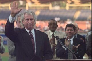 Don Sutton acknowledges applause at the conclusion of a ceremony to retire his number
