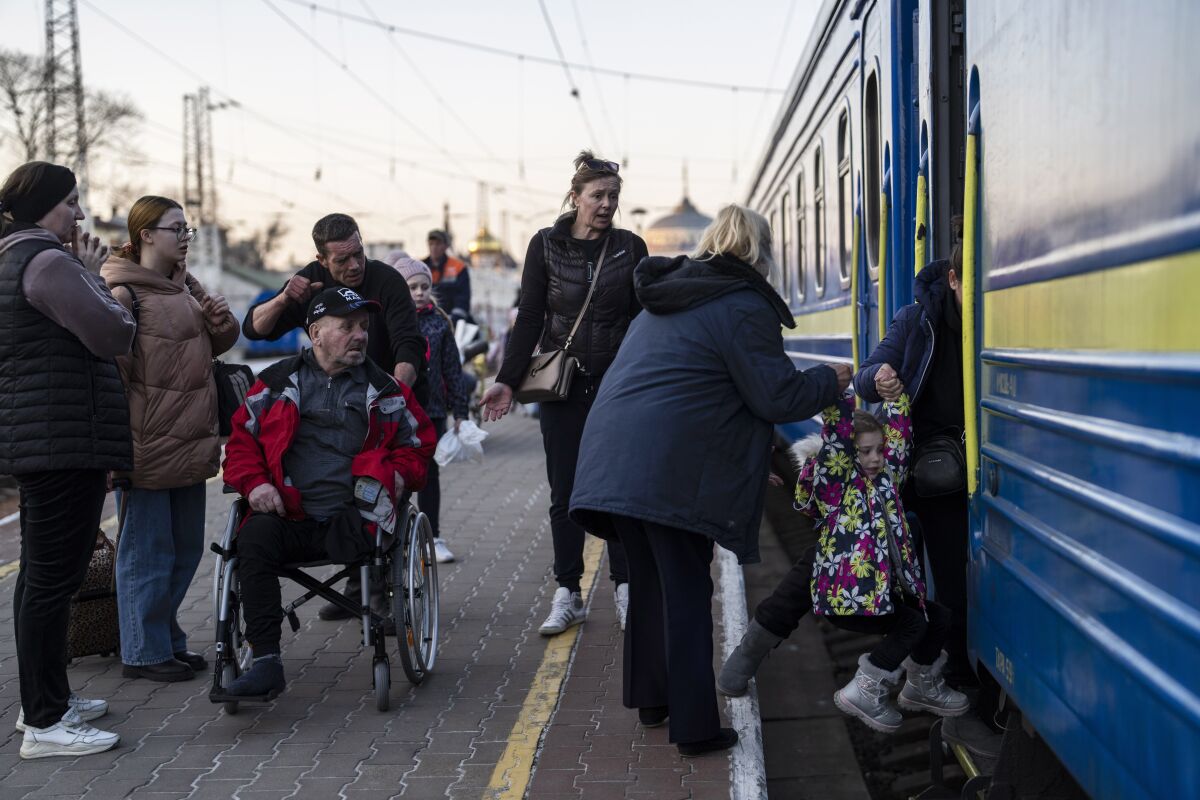 FILE - People embark a train in Odesa, southern Ukraine, on March 23, 2022. Rising food prices as a result of the Russian invasion of Ukraine are increasing the risk of malnutrition of millions of children in the Middle East and North Africa, the U.N. children’s agency warned Thursday, April 7. (AP Photo/Petros Giannakouris, File)