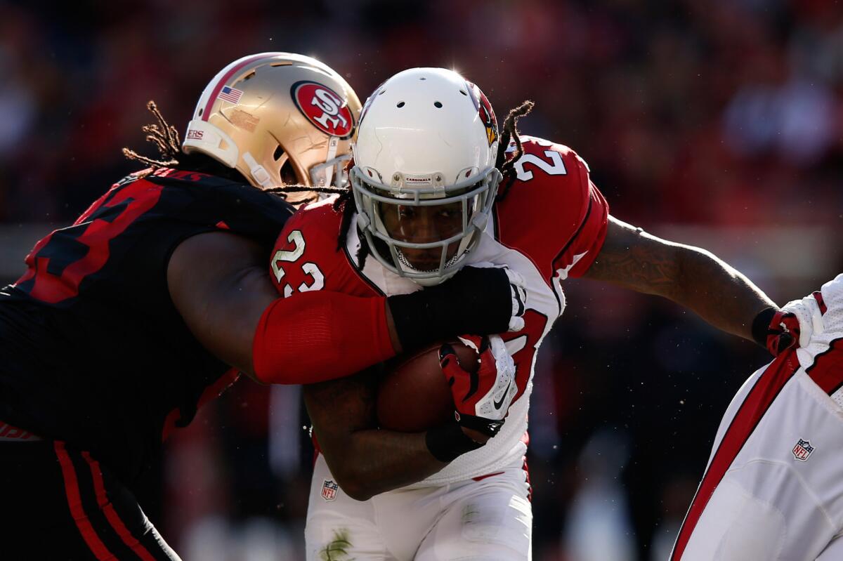 Cardinals running back Chris Johnson is hit by 49ers defensive lineman Ian Williams at the line of scrimmage.