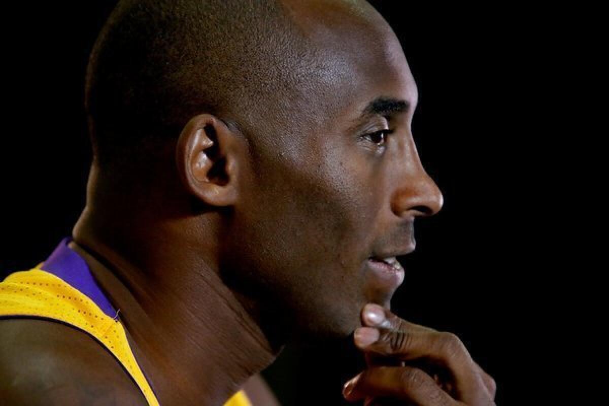 Kobe Bryant talks to reporters during the Lakers' media day at the team's training facility in El Segundo.