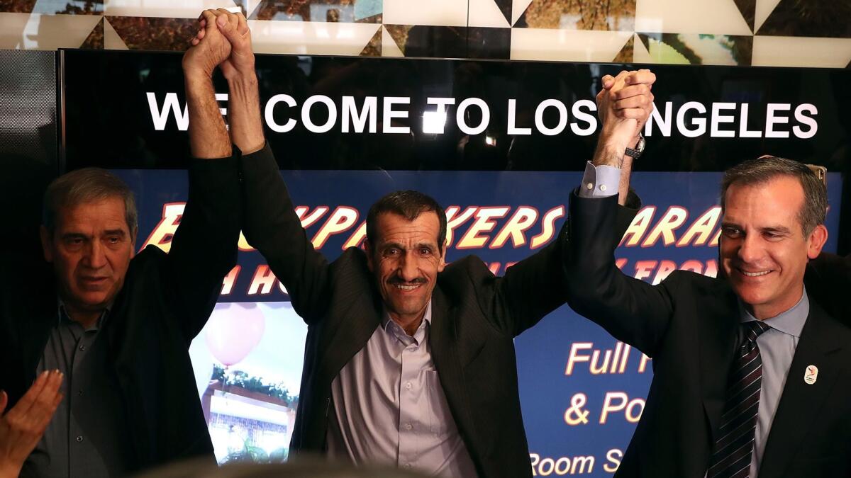 Iranian Ali Vayeghan, center, was sent back to Iran after arriving at LAX on the day Trump’s travel ban was implemented. After a legal fight, he has been allowed to return to the U.S.