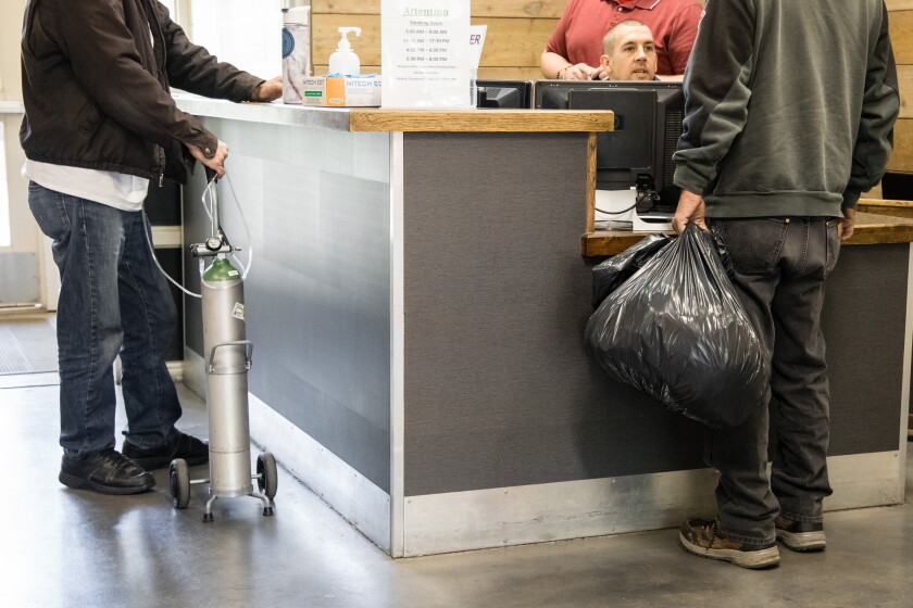 Men check in for the night at the River of Life Men’s Shelter in Boise, Idaho. 