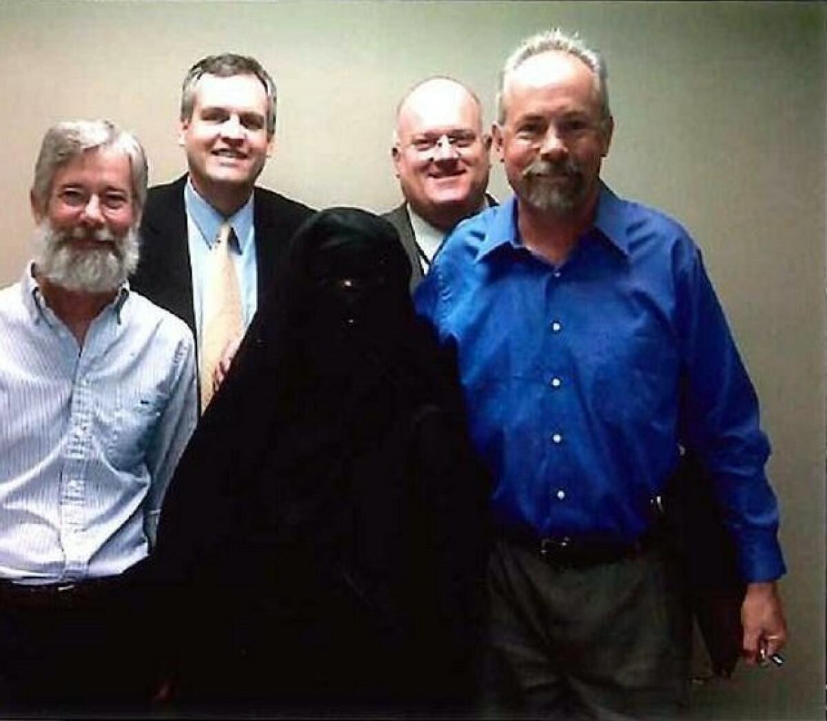 Engineering manager George Briest, human resources manager Thomas Wood, operations manager Tom Kennedy and retired operations supervisor Eric Phillips posed with Kim Thorner, in the office in November 2009.