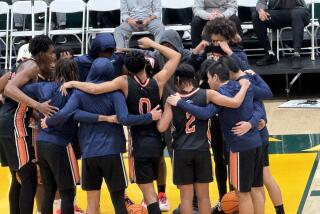 Eastvale Roosevelt players coming together before their 71-66 win over Owyhee at the Classic at Damien.