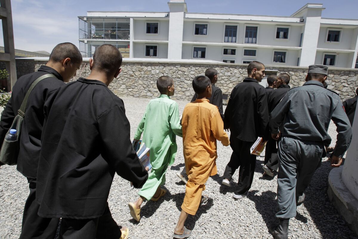 Inmates at the juvenile rehabilitation center in Kabul, Afghanistan, return to their cells.