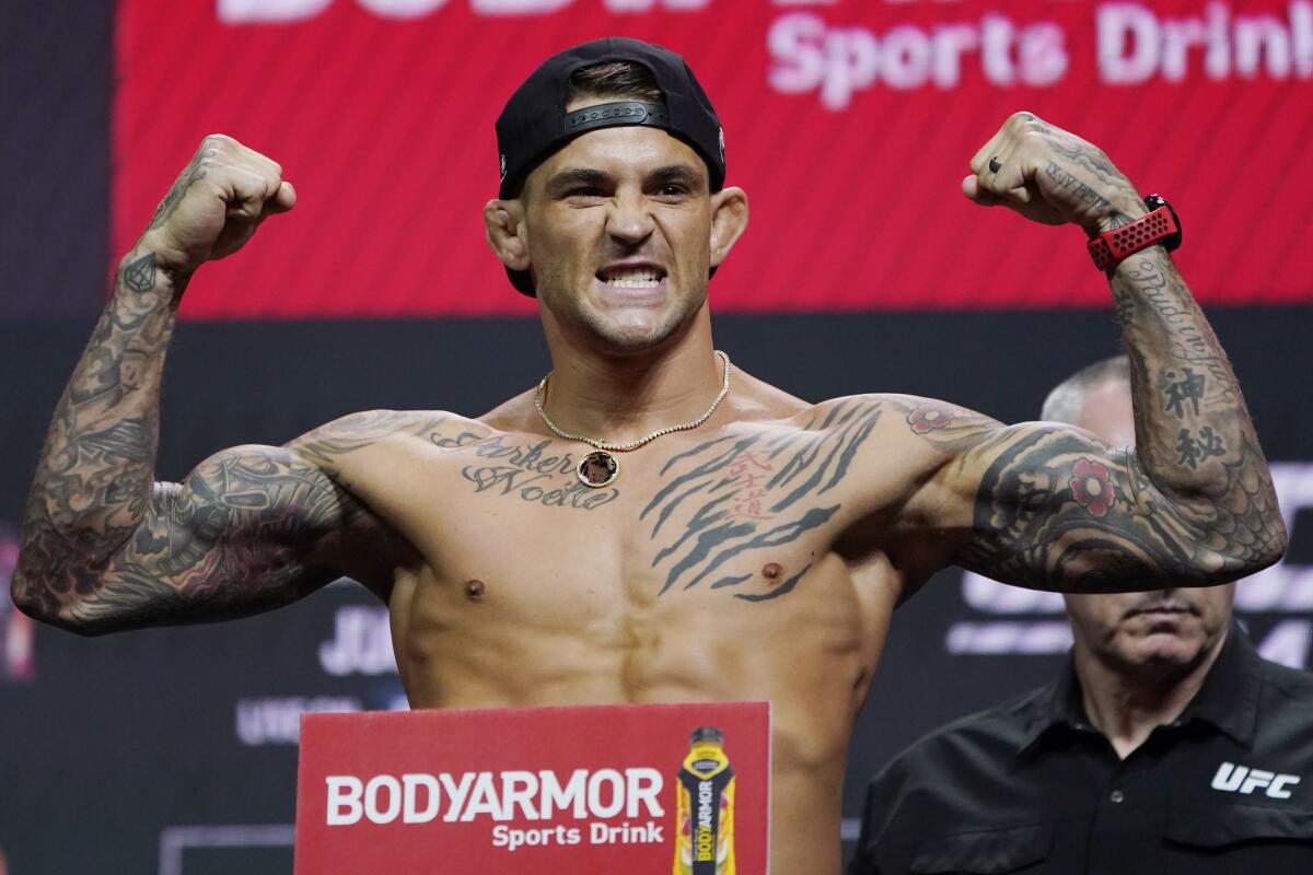 Dustin Poirier poses during a ceremonial weigh-in for a UFC 264 