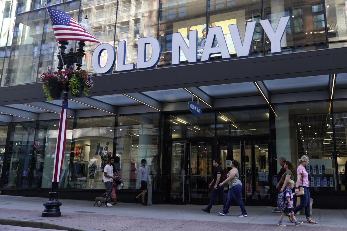 Pedestrians pass the Old Navy store in the Downtown Crossing shopping area, Wednesday, July 14, 2021, in Boston. Gap’s low-price division Old Navy is overhauling its approach to how it designs and markets to plus-size women, a growing demographic that many analysts say has been underserved. Starting Friday, Aug. 20, Old Navy will be offering every one of its women’s styles in all sizes with no price difference. (AP Photo/Charles Krupa)
