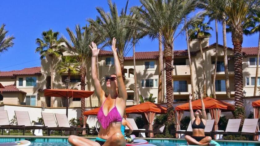 Relax with a SUP yoga class that takes place in a swimming pool.