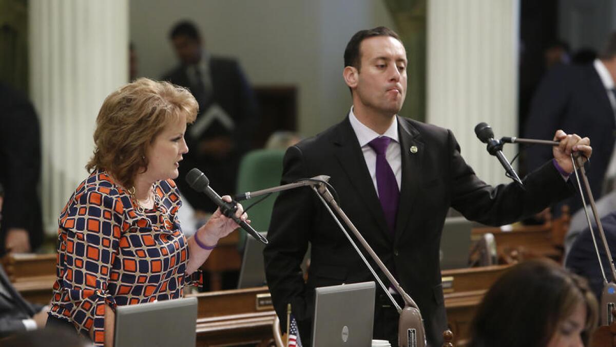 The legal troubles of Assemblyman Roger Hernandez (D-West Covina), shown in September 2013, have become a political headache for Assembly Democrats. At left is Assemblywoman Shannon Grove (R-Bakersfield).