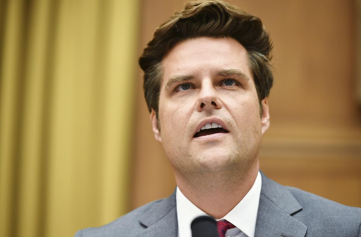  Matt Gaetz speaks before a microphone