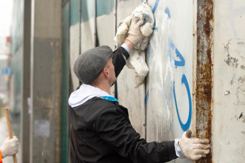 a man cleaning up graffiti