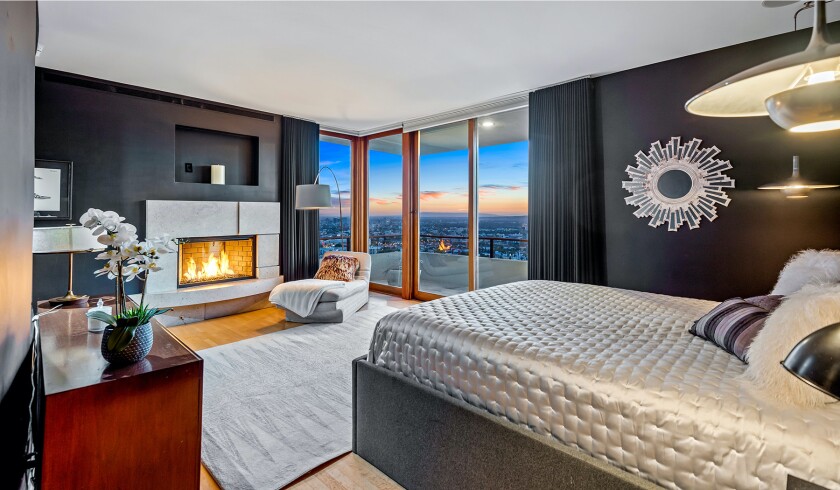 The hillside home includes three levels of decks, balconies and patios, as well as a swimming pool and spa.