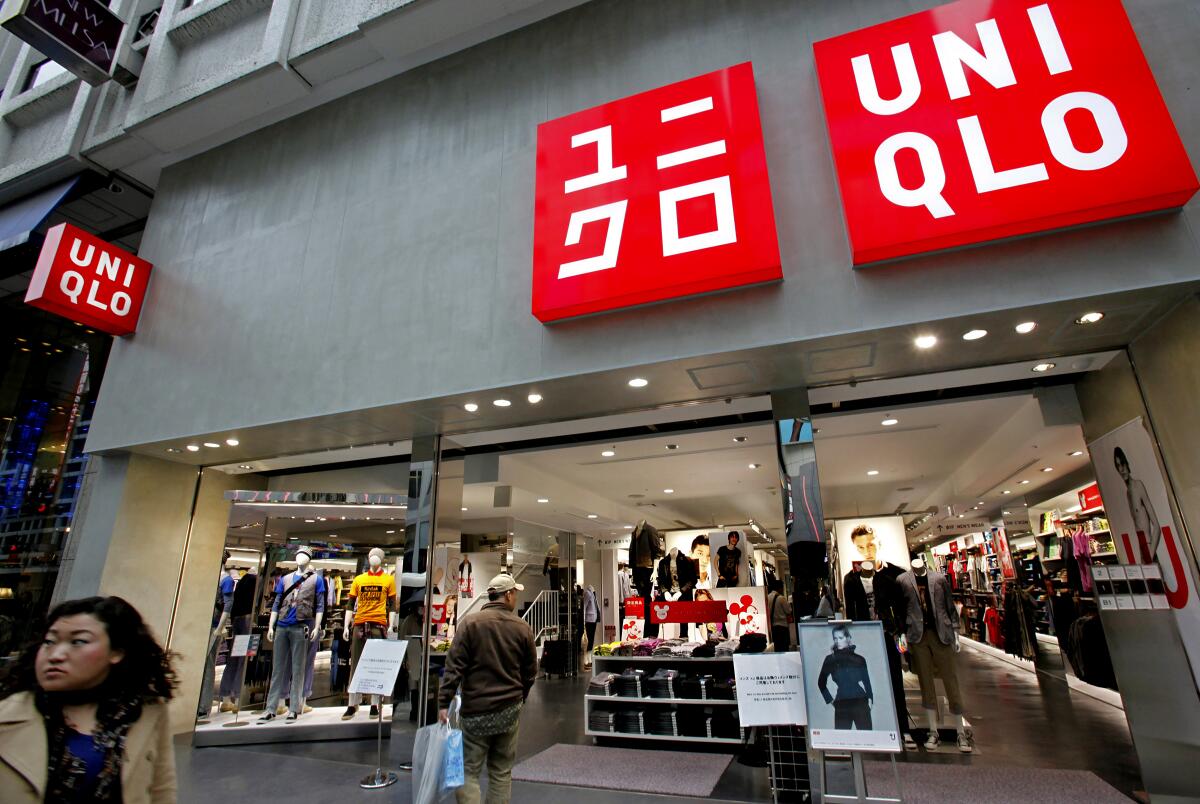 A passerby looks into a Uniqlo shop in Tokyo.