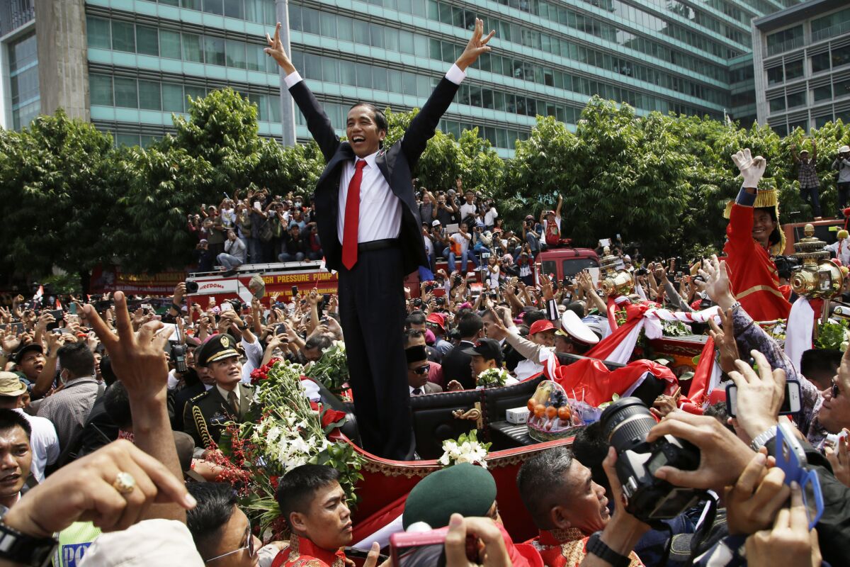 Indonesian President Joko Widodo gestures to the crowd during a parade following his inauguration in Jakarta on Oct. 20.