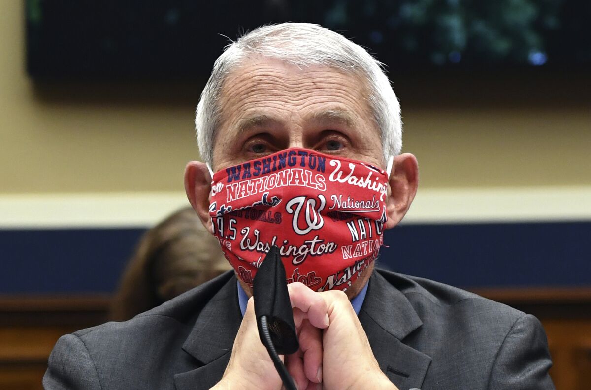 FILE- In this June 23, 2020 file photo, Director of the National Institute of Allergy and Infectious Diseases Dr. Anthony Fauci wears a face mask as he waits to testify before a House Committee on Energy and Commerce on the Trump administration's response to the COVID-19 pandemic on Capitol Hill in Washington. Made during a May 21, 2020 interview on CNN, Fauci's pleas for people to "wear a mask" to slow the spread of the coronavirus, tops a Yale Law School librarian's list of the most notable quotes of 2020. (Kevin Dietsch/Pool via AP, File)