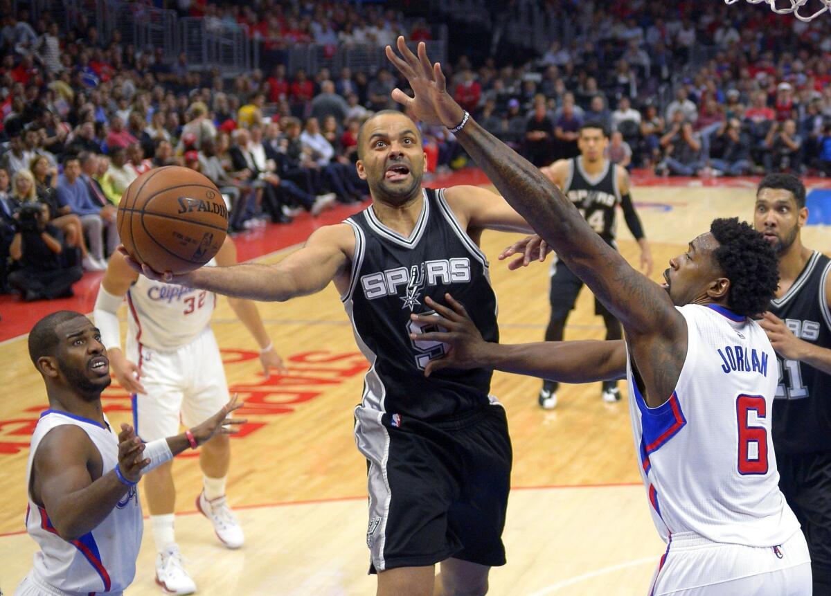 Clippers Chris Paul, left, and DeAndre Jordan defend against San Antonio's Tony Parker on April 28.